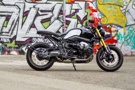 BMW R nineT — Fiancata destra completa, laterale pura, muro di graffiti a tutta larghezza.