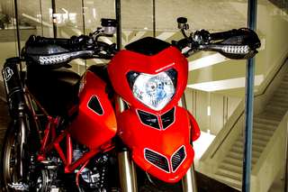 Ducati Hypermotard 1100 — Tre quarti anteriore sinistro: mascherina, paramani, pompa freno, manubrio.