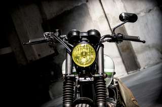 Kawasaki W800 — Frontale ravvicinato: faro giallo, doppia strumentazione, soffietti forcella.